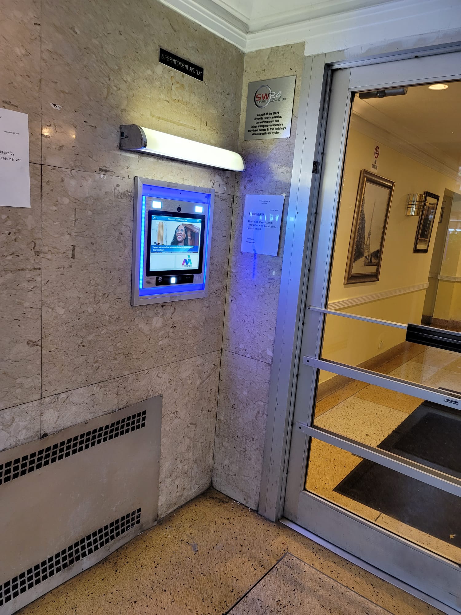 mvi keycom mounted on marble wall by building entrance