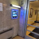 mvi keycom mounted on marble wall by building entrance