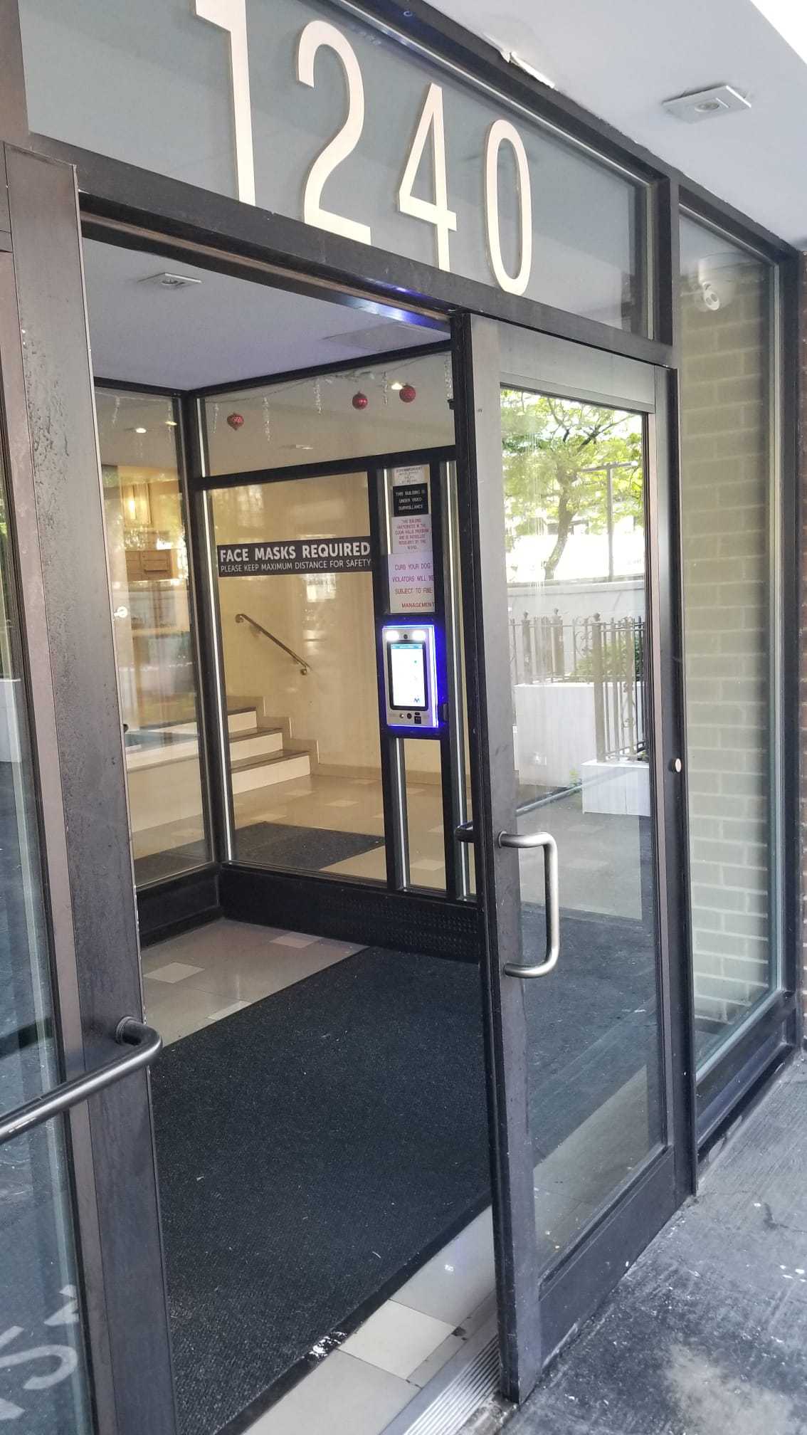 mvi keycom mounted on wall by office building entrance