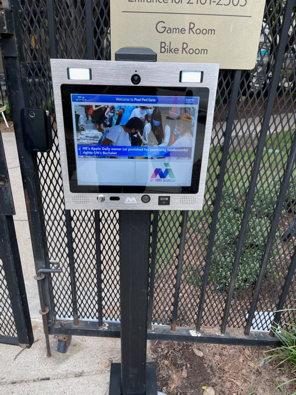 mvi keycom mounted on metal stand by gated entrance