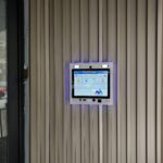 mvi keycom mounted on metal wall by building entrance