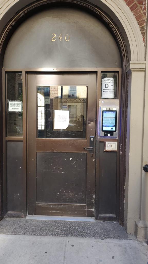 mvi keycom system mounted on metal door by building entrance
