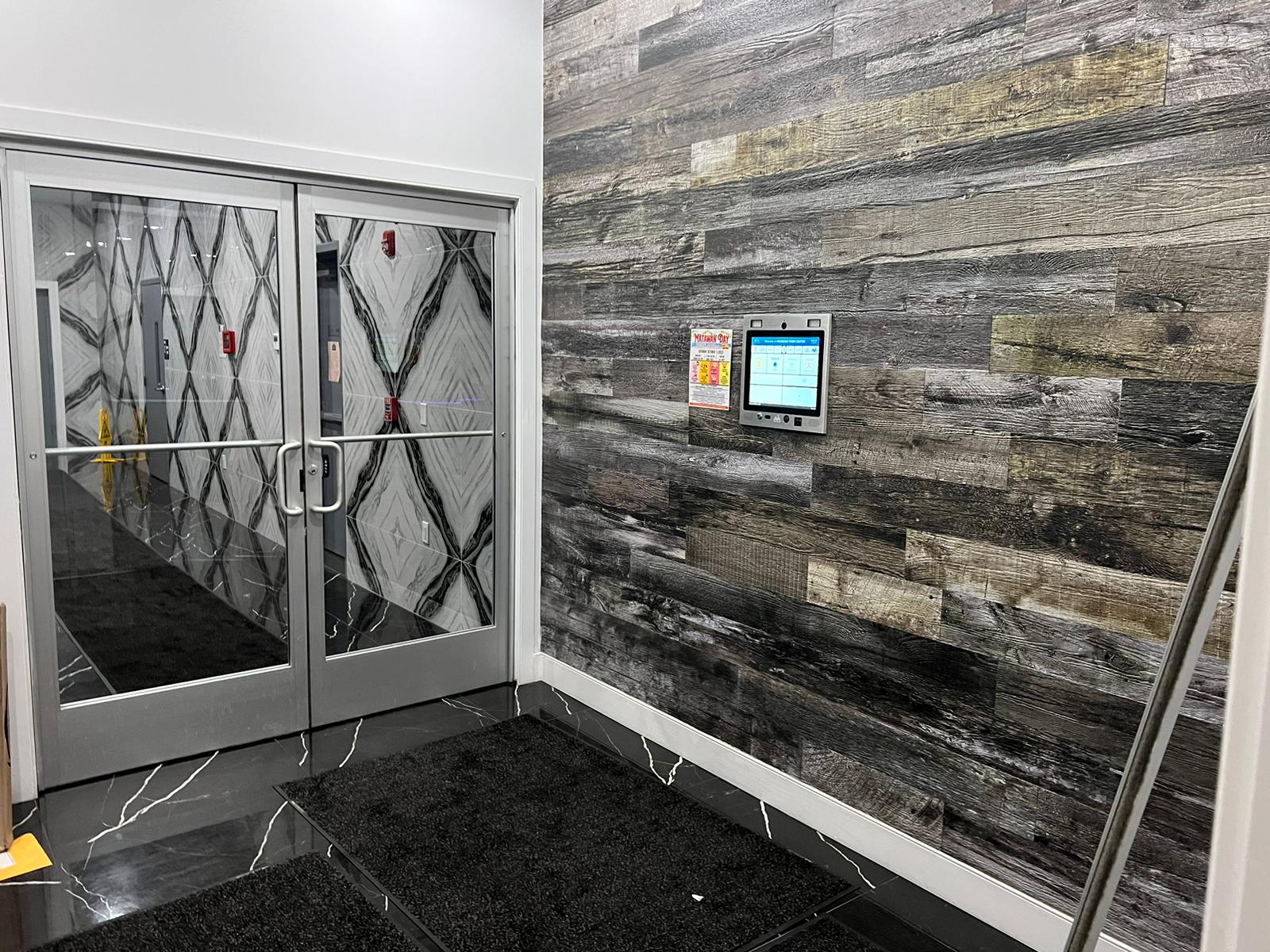 mvi access system installed on wood wall by apartment entrance